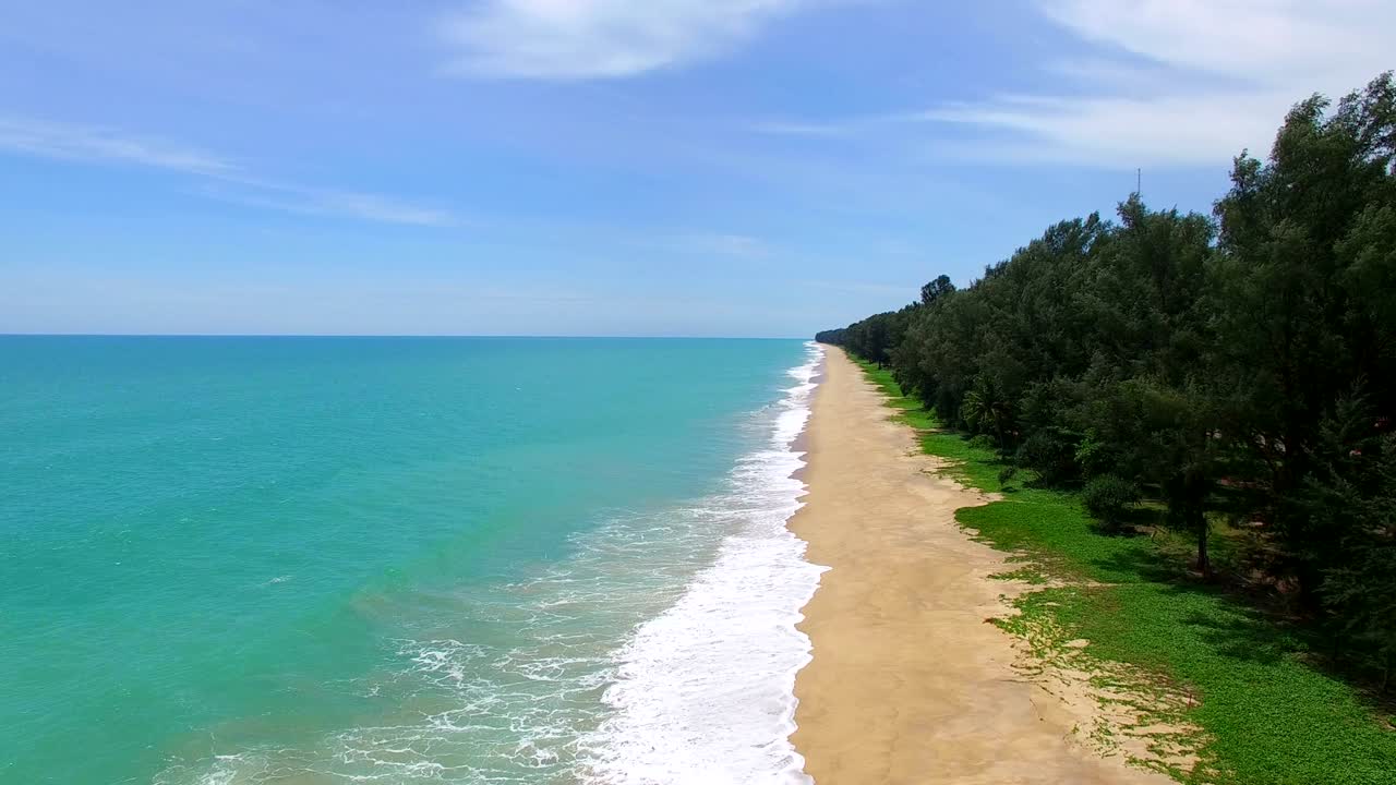 aerial view big waves of Andaman sea hit on the long beach.