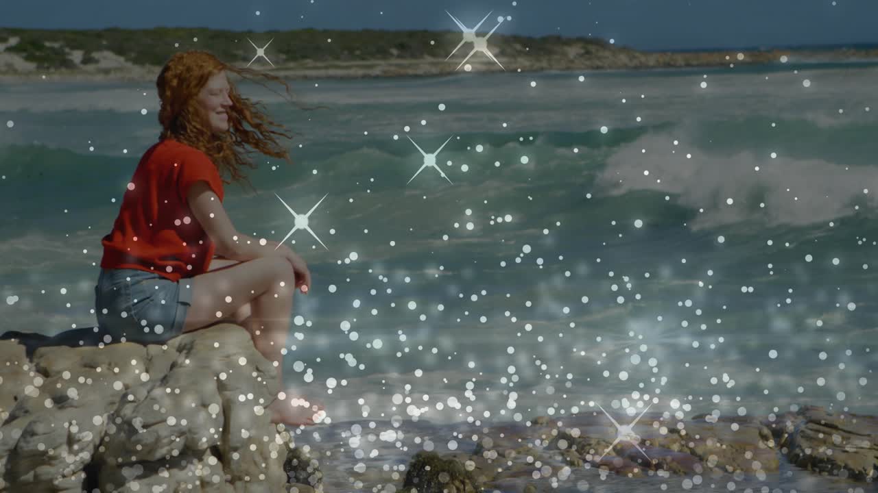 Traveler relaxing at seaside watching waves as breeze lifting hair with travel ad sparkling overlay