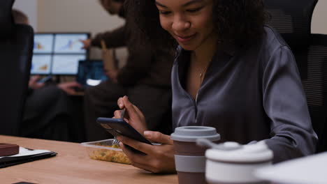 businesswoman eating lunch in office