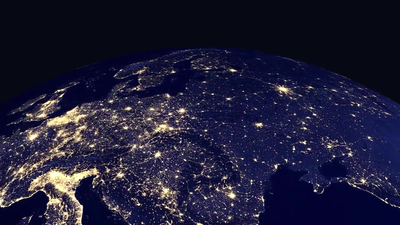 Digital animation zooms from space into a glowing night view of Warsaw, Poland on Earth