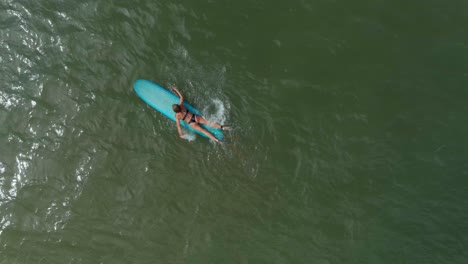 Birds-eye-view-of-female-surfer-in-the-Gulf-of-Mexico-off-the-coast-of-Lake-Jackson-in-Texas