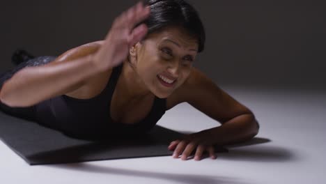 Close-Up-Studio-Shot-Of-Two-Mature-Women-Wearing-Gym-Fitness-Clothing-Doing-Plank-Exercise-Together