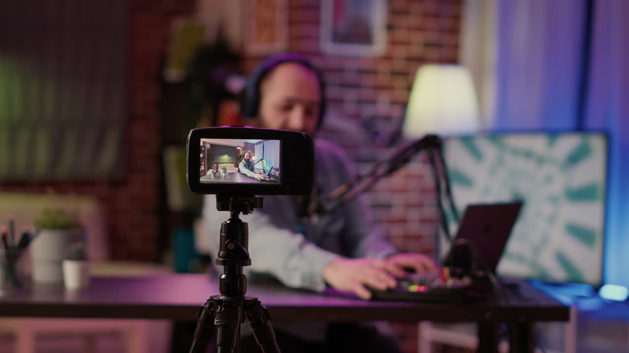 Selective focus on digital video camera screen recording influencer caucasian man streaming live talk show using microphone