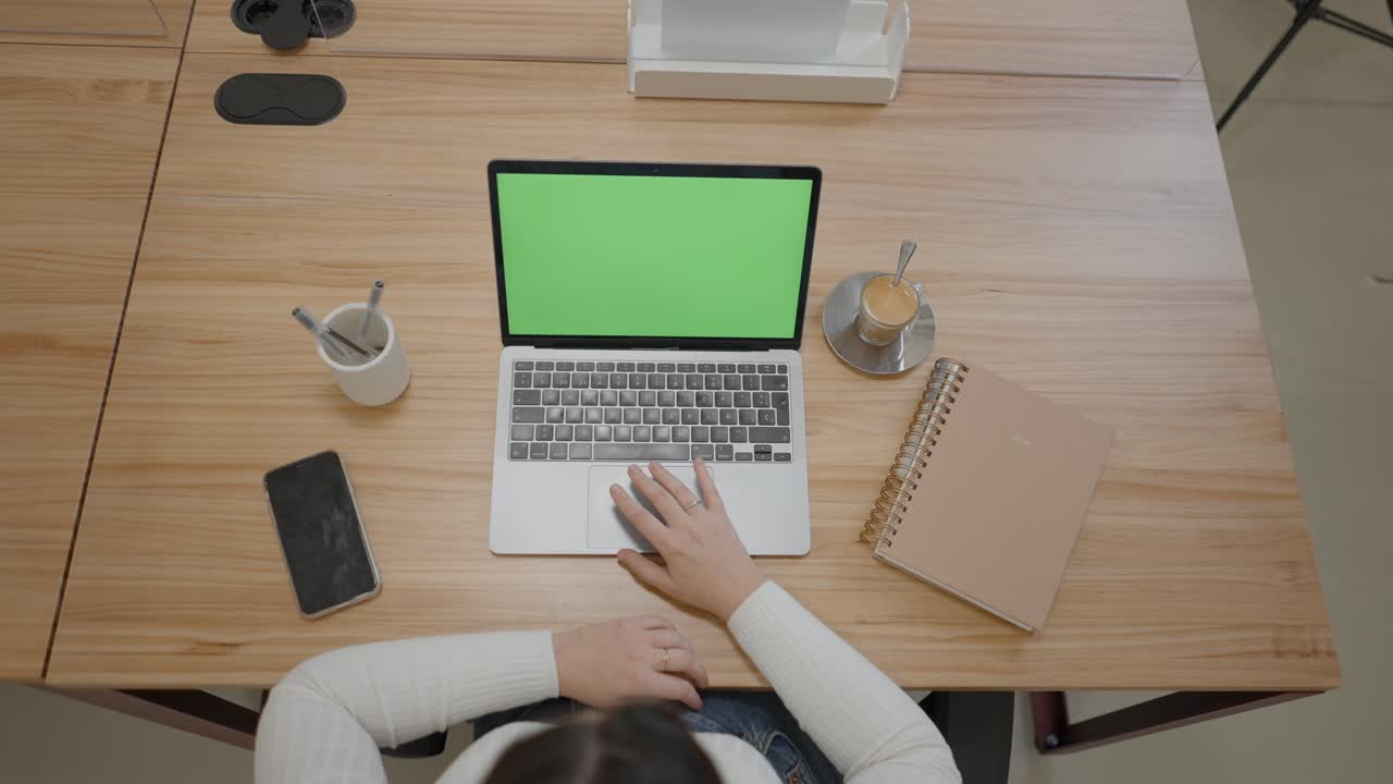 Person Working on Laptop at a Modern Office Desk
