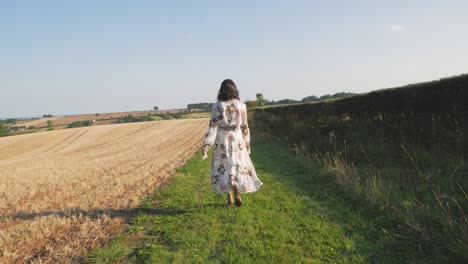 slow motion follow shot as a woman in a long flowery dress spins