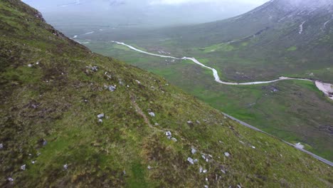 Road-isolated-appears-behind-huge-mountain-in-remote-countryside