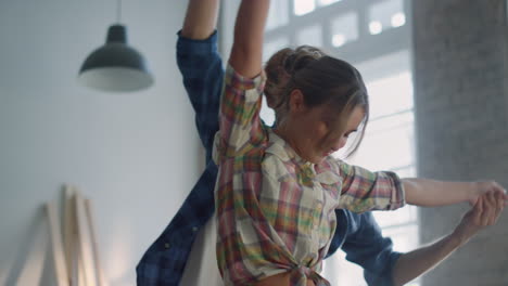 Happy-couple-having-fun-in-new-apartment.-Family-enjoying-house-renovation