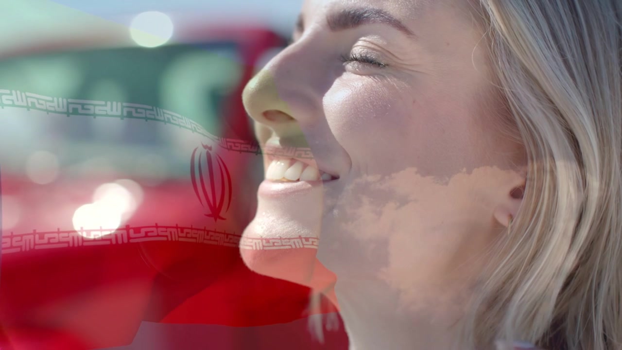 Woman touching face near red car adjusting hair smiling while flag overlaying face for marketing
