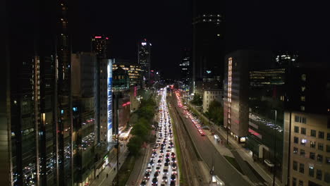 Ascending-footage-of-traffic-jam-in-multilane-road.-Long-standing-queue-of-cars-leading-through-nigh-city.-Warsaw,-Poland