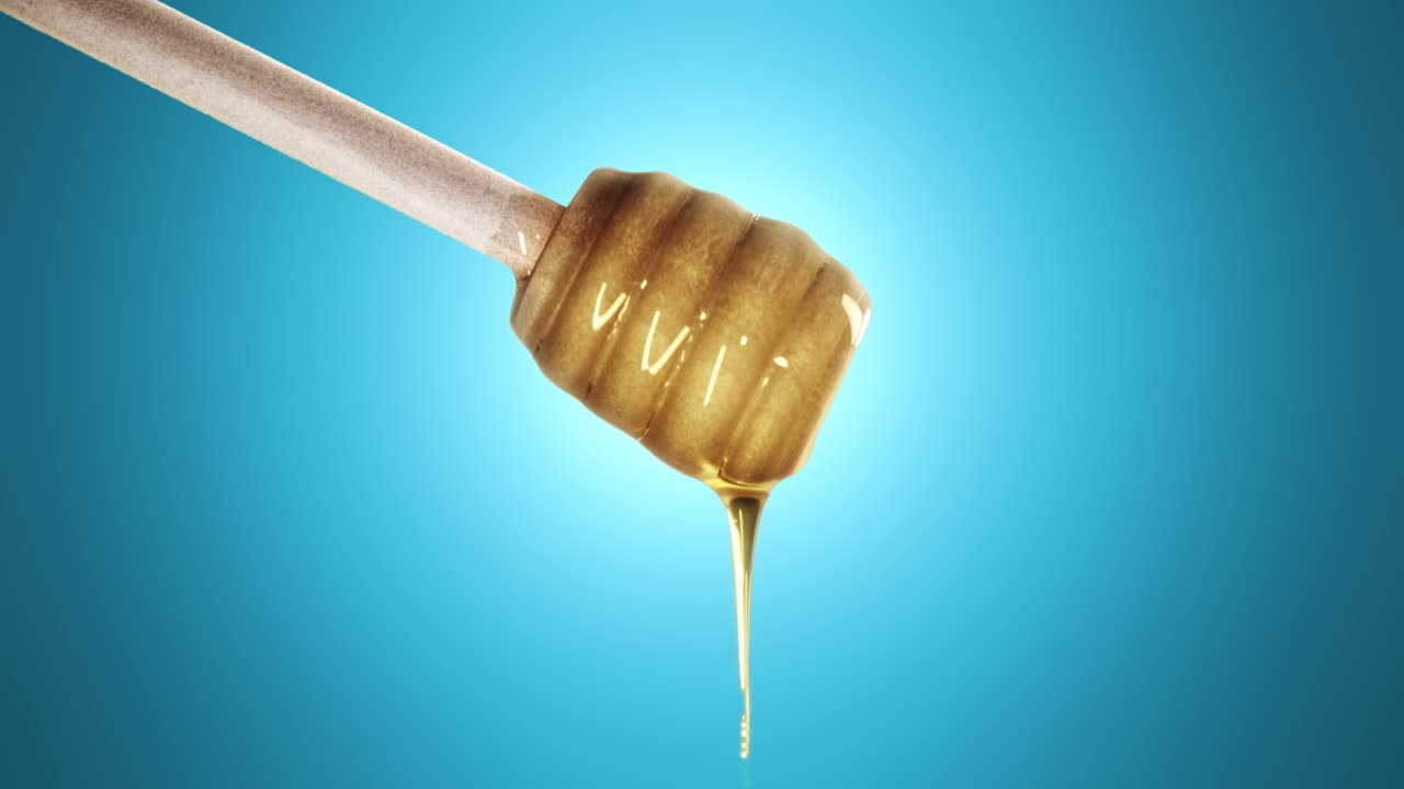 Honey dripping from honey dipper on blue background