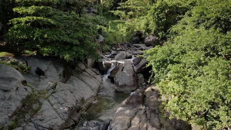 DRONE-AERIAL-SHOT-IN-WATERFALL-AND-RIVER-OF-ANOTHER-DJI-DRONE-HOVERING