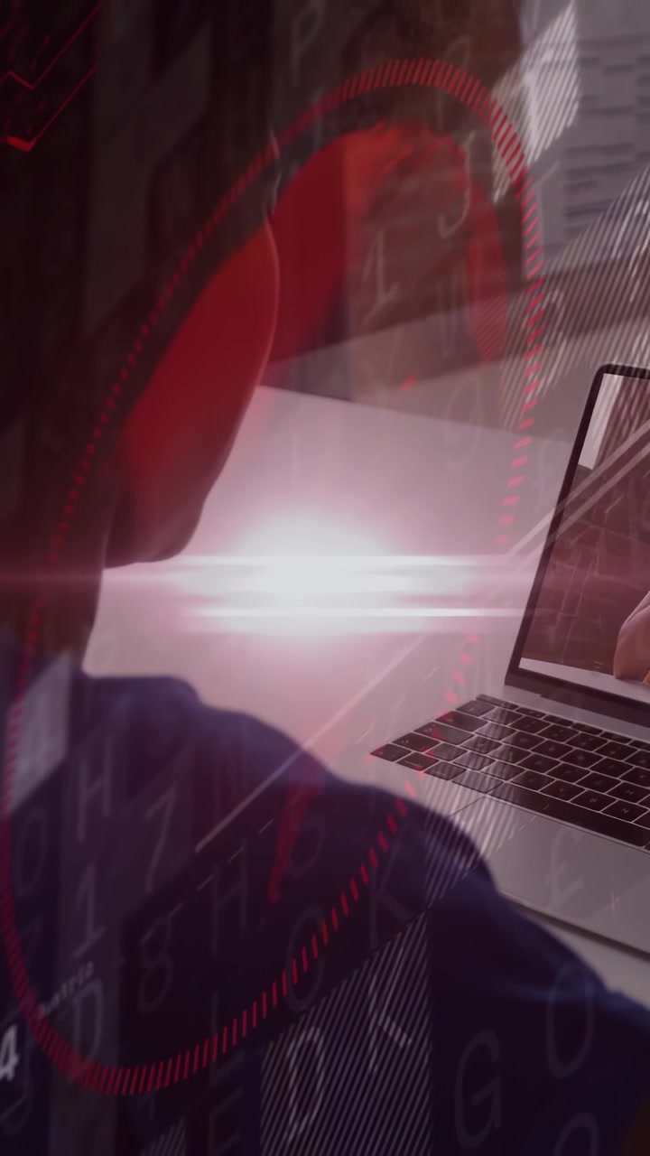 Leaning woman in navy top focusing on laptop at desk, viewing on-screen hand and HUD overlays