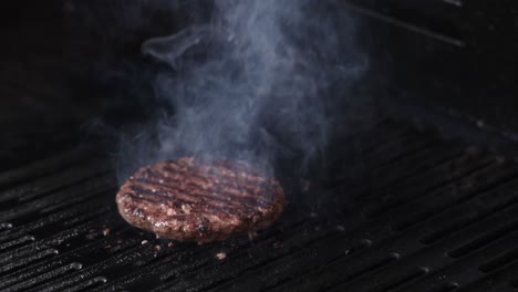 burger patty cooking with rising smoke