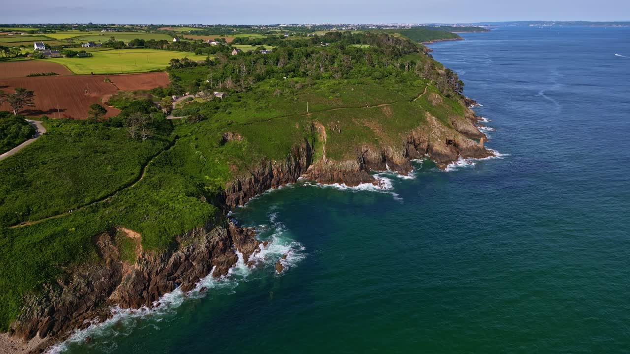 High-altitude backward drone movement from the Plouzané shoreside near Phare du Petit Minou, Finistère, France