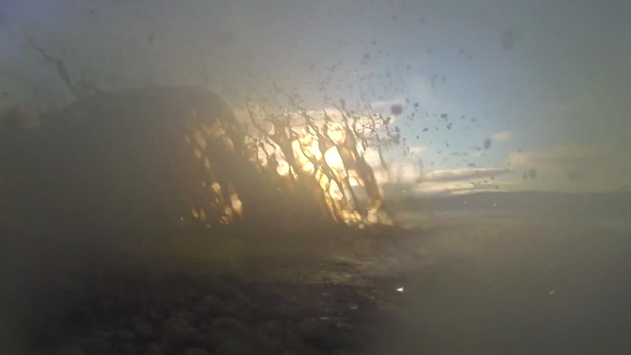 느린 동작으로 아이슬란드 고원의 진흙탕에 자동차가 튀었습니다.