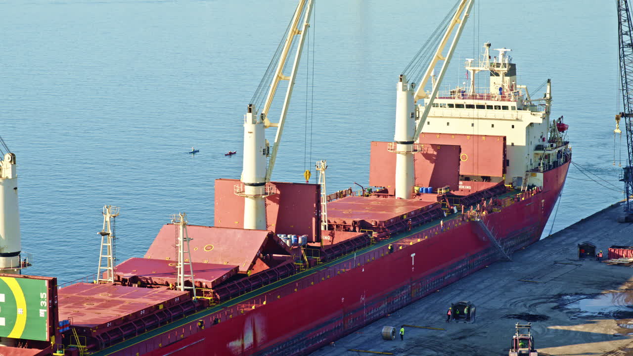 Drone shot cruising above the Detroit River, framing the freighter and city skyline beautifully