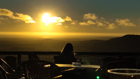 woman-sitting-on-the-terrace-of-a-viewpoint