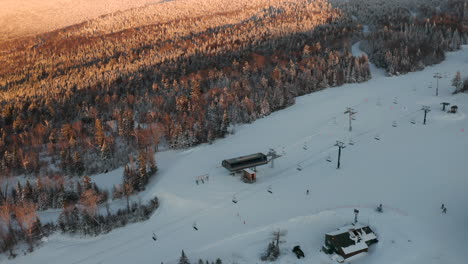 Saddleback-Maine-Ski-Lift-Pan-up-to-Mountain-during-beautiful-golden-hour-sunset