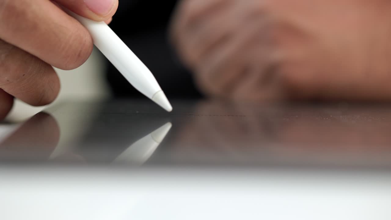 Businessman signing a business contract with stylus pen on tablet. Man signing contract on tablet at office. Business and technology concept. Electronic signature concept