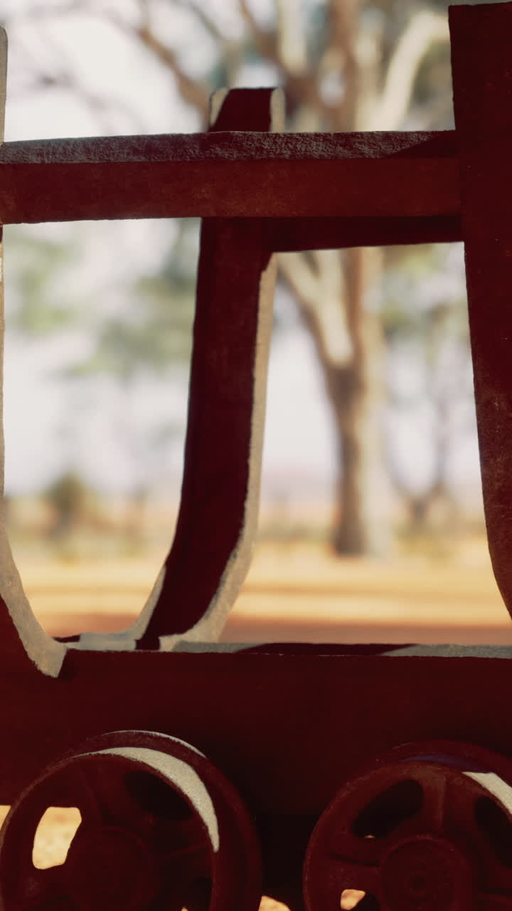 Old wooden cart resting against a backdrop of dusty earth and trees