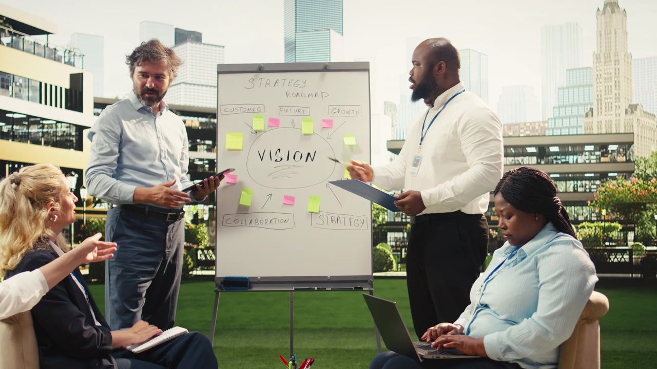 Diverse Business Team Collaborating on Strategy Roadmap in Outdoor Office