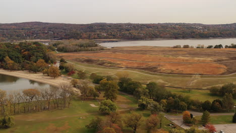 aerial drone dolly shot in, over croton point park while it was void of activity - people, on a cloudy day showing the beautiful colors of the autumn season