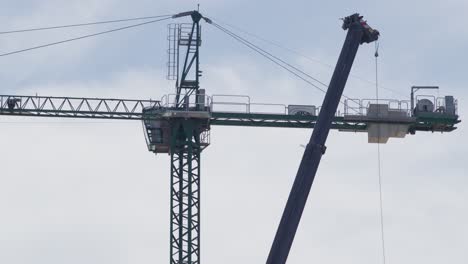 construction crane at a building site in argentina, with high-rise structures in the background