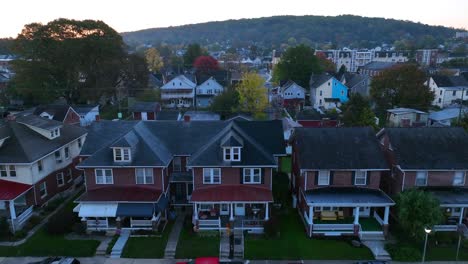 Twilight-over-a-serene-residential-street-lined-with-traditional-American-homes-and-parked-cars