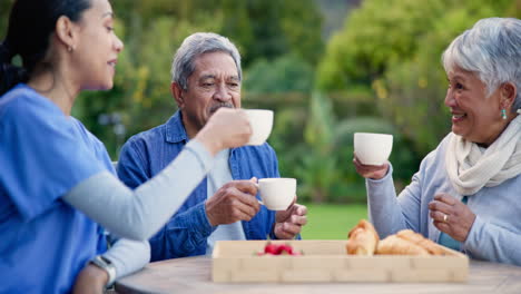 Cheers,-nurse-and-a-couple-with-coffee-in-a-garden