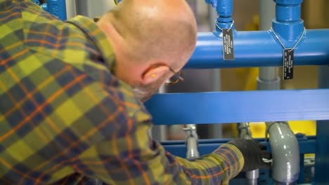 worker checking pipes to see if everything is working correctly