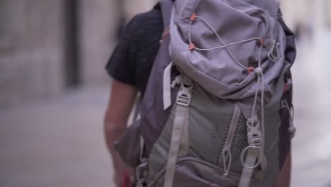 person walking with backpack and barefoot