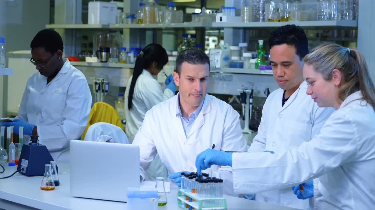Team of scientists interacting with each other 4k