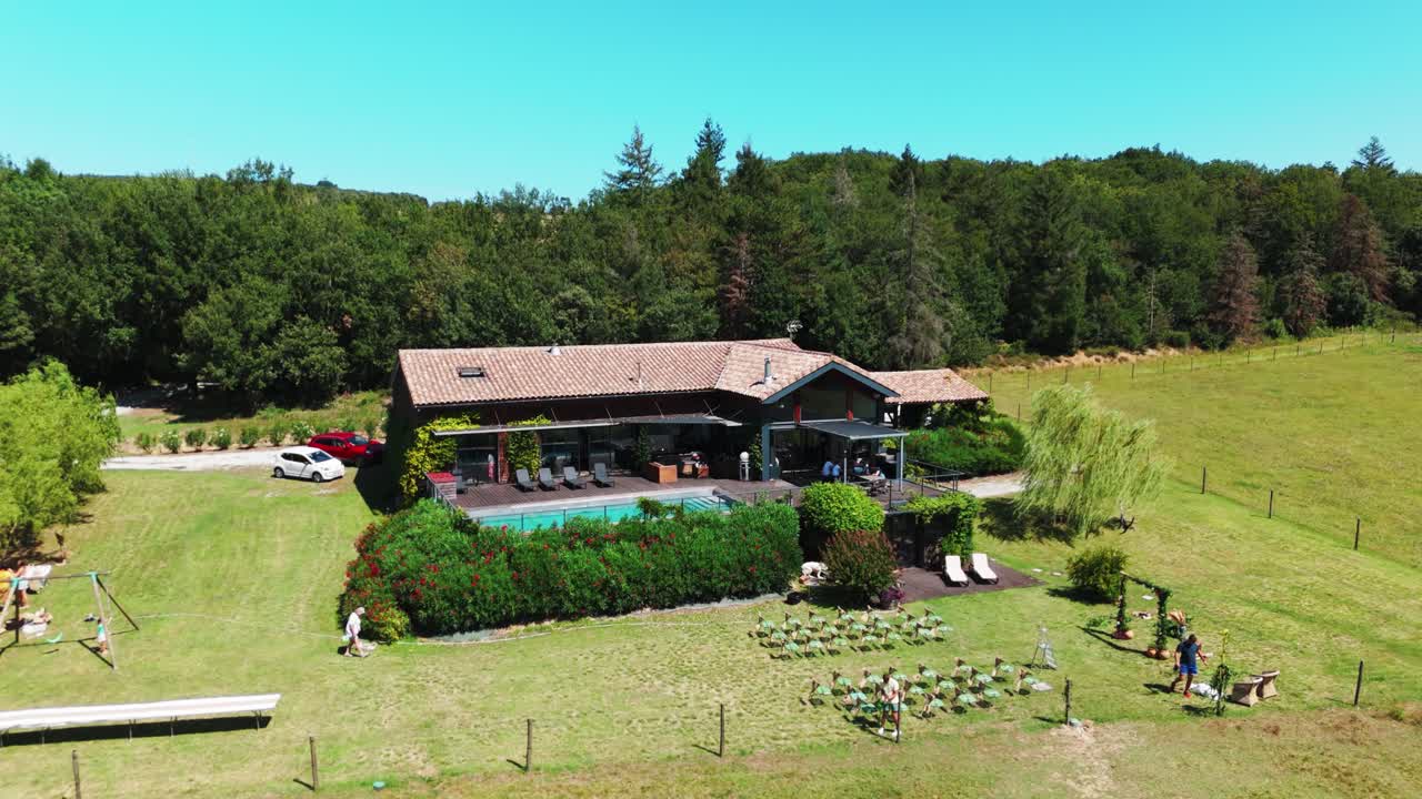 Aerial orbiting shot of a exterior wedding venue getting prepared for a wedding