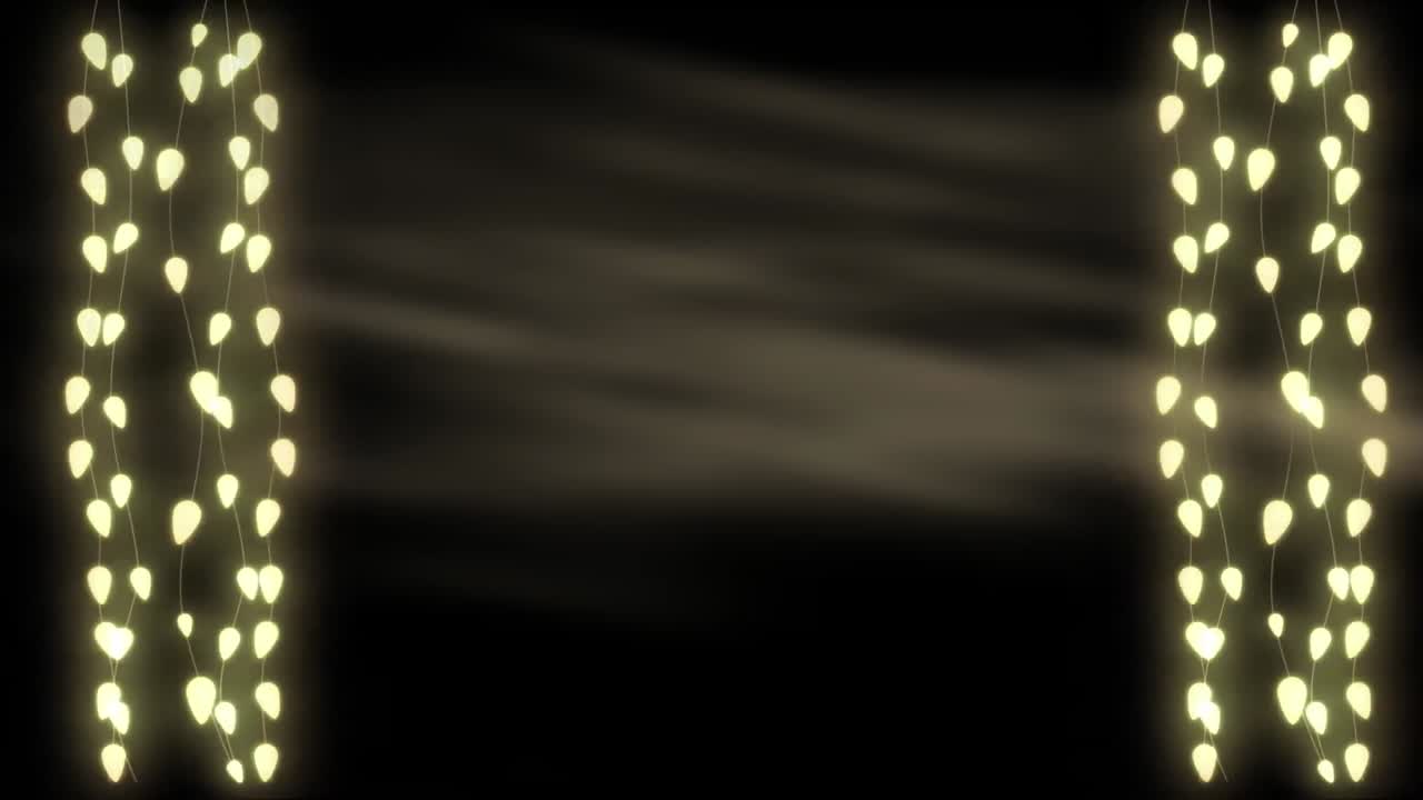 Glowing strings of fairy lights on grey background