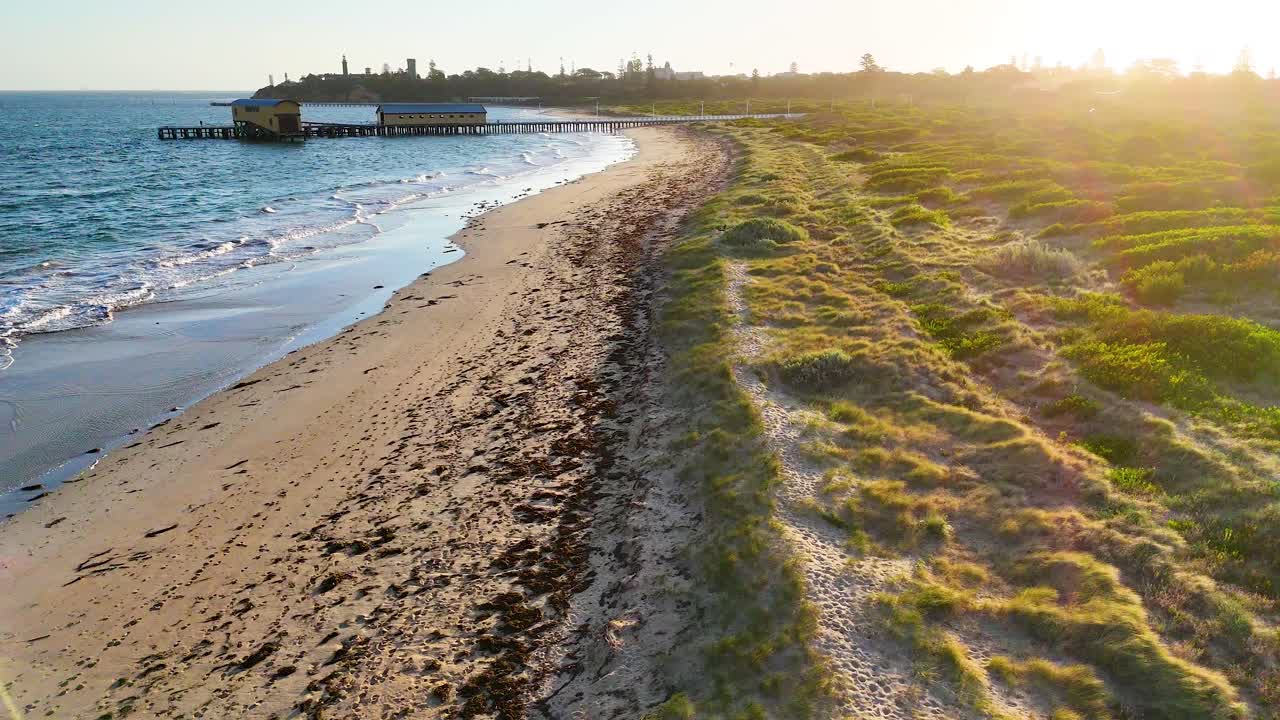 Aerial view of a tranquil beach path at sunset in Bellarine, Victoria, showcasing natural beauty and calm waters