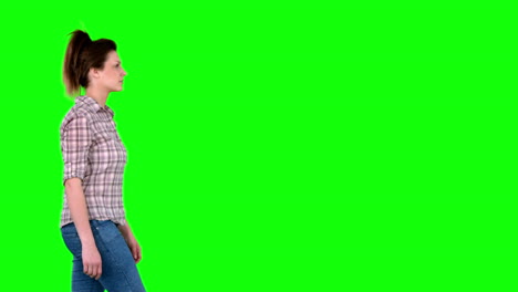casual brunette walking on green screen