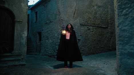 mysterious woman walks through the alleys of the medieval city at night