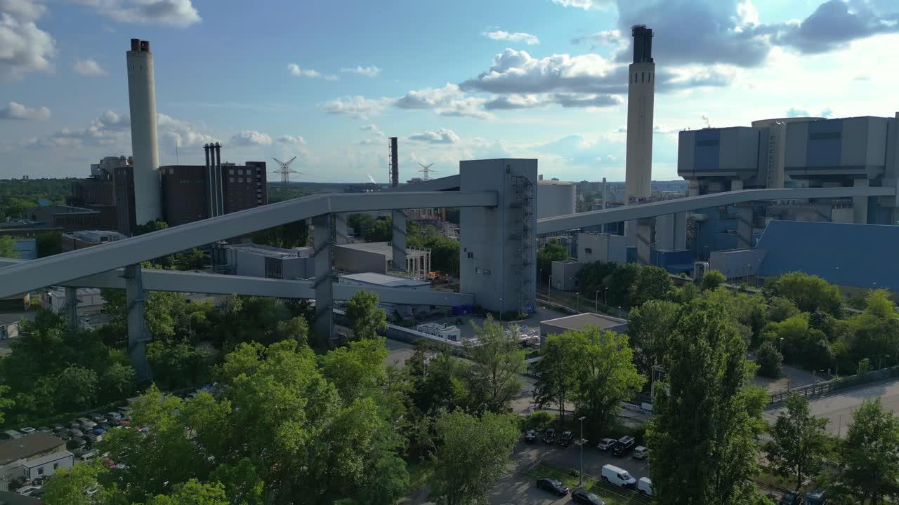 hard coal fired power station transporting coal on conveyor belts, showcasing industrial infrastructure in a city. Great aerial view flight descending drone