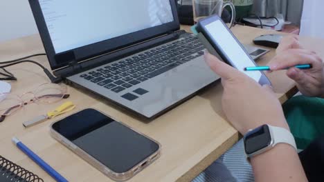 hands of a creative professional using a tablet with a stylus for design or illustration