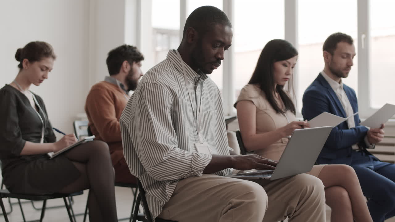 African Man Using Laptop in Boardroom
