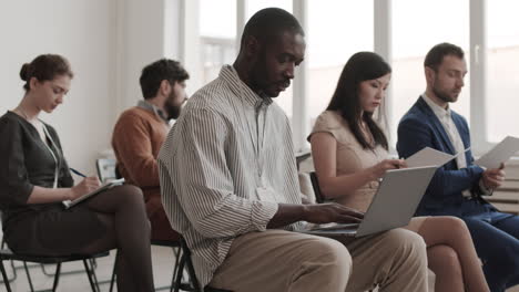 african man using laptop in boardroom