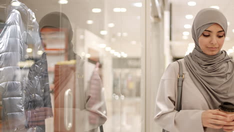 woman in hijab shopping and enjoying coffee in a mall