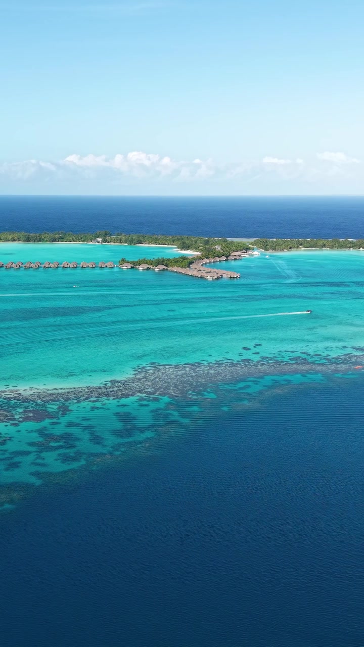 Bora Bora Island Lagoon and Luxury Resort With Overwater Bungalows, Vertical Drone Shot, French Polynesia