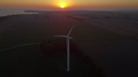 aerial shot of windmill electrical energy power generator during beautiful sunset