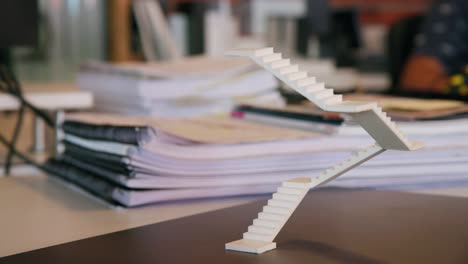 foam staircase model sitting freely on architects desk in office, camera pan