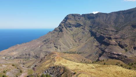 tamadaba natural park, tirma: aerial view traveling in a fantastic landscape with high mountains and roque faneque in this natural park on the island of gran canaria on a sunny day