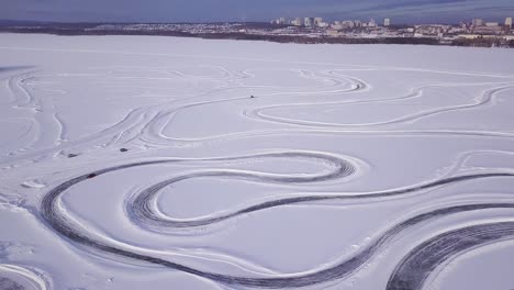 aerial view of an ice track on a frozen lake
