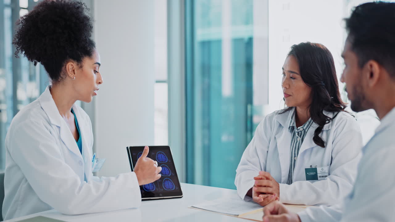 Medical Professionals Discussing Brain Scan on Tablet