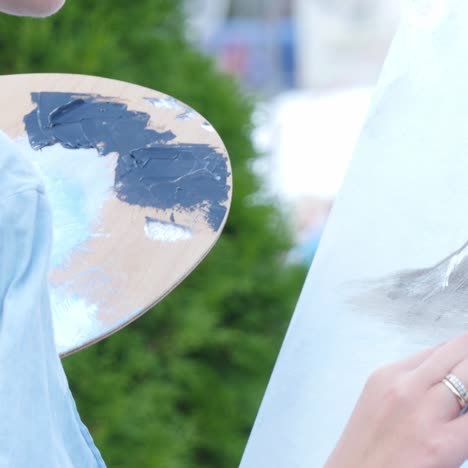hand holding a paintbrush