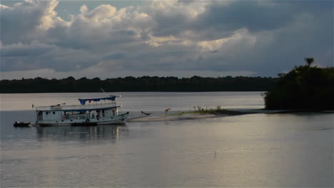 river boats come into a small harbor on the amazon river in brazil